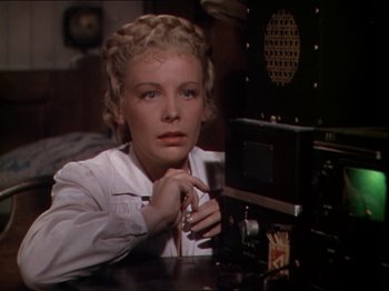 Movie still from “The Story of Dr. Wassell” (1944), directed by Cecil B. DeMille – A woman sitting in front of a microwave oven; Close Up shot, Low angle