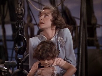 Movie still from “The Story of Dr. Wassell” (1944), directed by Cecil B. DeMille – An older woman holding a young girl in her arms; Medium shot, High angle
