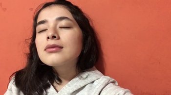 Movie still from “The Story of Film: A New Generation” (2021), directed by Mark Cousins – A woman with her eyes closed with her eyes closed; Close Up shot, Low angle