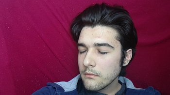 Movie still from “The Story of Film: A New Generation” (2021), directed by Mark Cousins – A young man with a beard is taking a nap; Close Up shot, Overhead angle