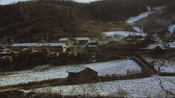 Movie still from “The Story of Qiu Ju” (1992), directed by Yimou Zhang – A small village in the middle of a snow covered field; Extreme Wide shot, High angle