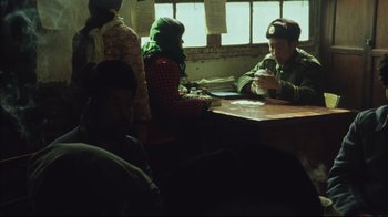 Movie still from “The Story of Qiu Ju” (1992), directed by Yimou Zhang – A group of people sitting around a table; Medium shot, High angle