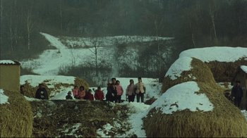 Movie still from “The Story of Qiu Ju” (1992), directed by Yimou Zhang – A group of people standing on top of a snow covered slope; Extreme Wide shot, High angle