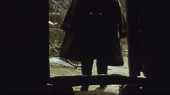 Movie still from “The Story of Qiu Ju” (1992), directed by Yimou Zhang – A person standing in the snow looking out of a window; Medium shot, Low angle