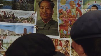 Movie still from “The Story of Qiu Ju” (1992), directed by Yimou Zhang – A picture of mao zedong on the wall of a building; Close Up shot, High angle