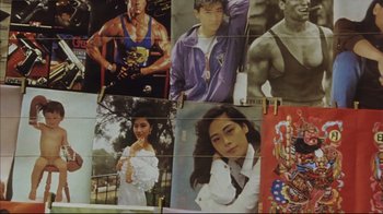 Movie still from “The Story of Qiu Ju” (1992), directed by Yimou Zhang – A bunch of pictures hanging on a wall; Medium shot, Low angle