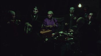 Movie still from “The Story of Qiu Ju” (1992), directed by Yimou Zhang – A group of people sitting around a table; Medium shot, High angle