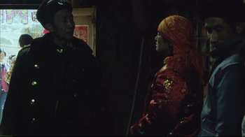 Movie still from “The Story of Qiu Ju” (1992), directed by Yimou Zhang – A man and a woman talking to each other in the dark; Medium shot, Over the shoulder angle