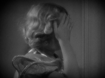 Movie still from “The Story of Temple Drake” (1933), directed by Stephen Roberts – A black and white photo of a woman covering her face; Close Up shot, Over the shoulder angle