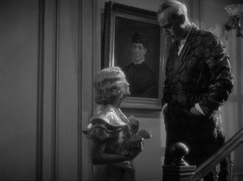 Movie still from “The Story of Temple Drake” (1933), directed by Stephen Roberts – An older man and a young woman standing in front of a painting; Medium shot, Over the shoulder angle