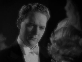 Movie still from “The Story of Temple Drake” (1933), directed by Stephen Roberts – A black and white photo of a man in a tuxedo; Close Up shot, Low angle