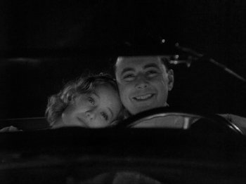 Movie still from “The Story of Temple Drake” (1933), directed by Stephen Roberts – A man and a woman smiling for the camera; Close Up shot, Low angle