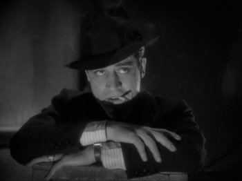 Movie still from “The Story of Temple Drake” (1933), directed by Stephen Roberts – A black and white photo of a man wearing a hat; Close Up shot, Low angle