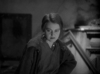 Movie still from “The Story of Temple Drake” (1933), directed by Stephen Roberts – A young girl is standing in front of a staircase; Medium shot, High angle