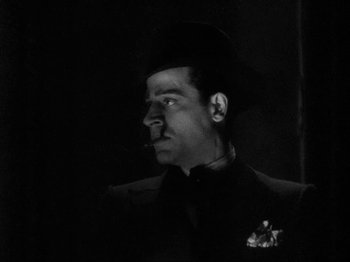 Movie still from “The Story of Temple Drake” (1933), directed by Stephen Roberts – A black and white photo of a man wearing a hat; Close Up shot, Low angle