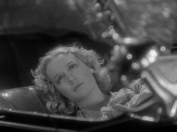 Movie still from “The Story of Temple Drake” (1933), directed by Stephen Roberts – Black and white photograph of a woman looking at herself in a mirror; Close Up shot, High angle