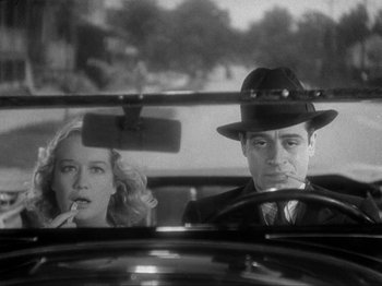 Movie still from “The Story of Temple Drake” (1933), directed by Stephen Roberts – A man and a woman sitting in the back of a car; Close Up shot, Low angle