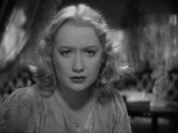 Movie still from “The Story of Temple Drake” (1933), directed by Stephen Roberts – A black - and - white photo of a woman with blonde curly hair; Close Up shot, High angle
