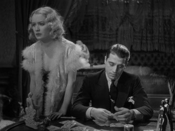 Movie still from “The Story of Temple Drake” (1933), directed by Stephen Roberts – A man and a woman sitting at a table with cards; Medium shot, High angle
