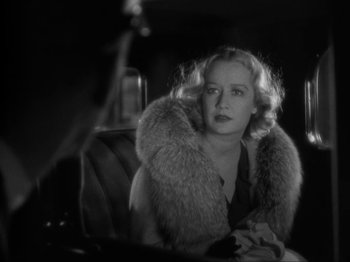 Movie still from “The Story of Temple Drake” (1933), directed by Stephen Roberts – A black and white photo of a woman in a car; Close Up shot, Over the shoulder angle