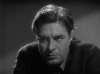 Movie still from “The Story of Temple Drake” (1933), directed by Stephen Roberts – Black and white photograph of a man in a suit; Close Up shot, Low angle