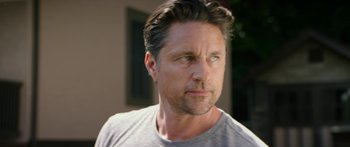 Movie still from “The Strangers: Prey at Night” (2018), directed by Johannes Roberts – A person wearing a gray t - shirt; Close Up shot, Over the shoulder angle