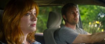 Movie still from “The Strangers: Prey at Night” (2018), directed by Johannes Roberts – A woman and a man sitting in the back seat of a car; Close Up shot, Over the shoulder angle