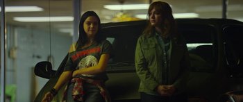 Movie still from “The Strangers: Prey at Night” (2018), directed by Johannes Roberts – Two women standing next to each other in front of a car; Medium shot, Over the shoulder angle