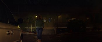 Movie still from “The Strangers: Prey at Night” (2018), directed by Johannes Roberts – A woman walking down a street at night; Wide shot, Low angle