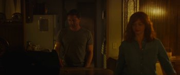 Movie still from “The Strangers: Prey at Night” (2018), directed by Johannes Roberts – A man standing at a table in front of a woman; Medium shot, Over the shoulder angle