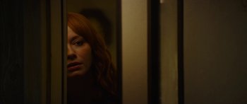 Movie still from “The Strangers: Prey at Night” (2018), directed by Johannes Roberts – A woman with red hair looking at a mirror; Close Up shot, Over the shoulder angle