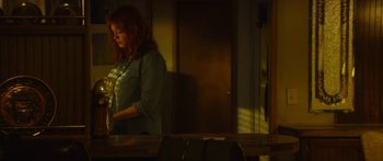 Movie still from “The Strangers: Prey at Night” (2018), directed by Johannes Roberts – A woman standing in front of a mirror in a room; Medium shot, Over the shoulder angle