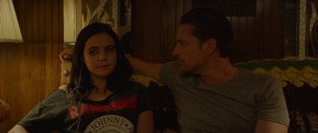 Movie still from “The Strangers: Prey at Night” (2018), directed by Johannes Roberts – A man and a woman sitting next to each other on a couch; Medium shot, Over the shoulder angle