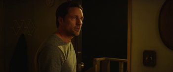 Movie still from “The Strangers: Prey at Night” (2018), directed by Johannes Roberts – A person in a room near a window; Close Up shot, Over the shoulder angle