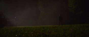 Movie still from “The Strangers: Prey at Night” (2018), directed by Johannes Roberts – A person standing in a field at night; Extreme Wide shot, Over the shoulder angle