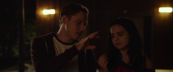 Movie still from “The Strangers: Prey at Night” (2018), directed by Johannes Roberts – A man and a woman standing next to each other in the dark; Medium shot, Over the shoulder angle