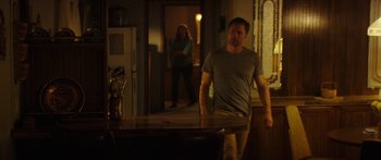 Movie still from “The Strangers: Prey at Night” (2018), directed by Johannes Roberts – A man and a woman standing in front of a table; Wide shot, Over the shoulder angle