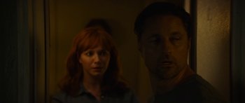 Movie still from “The Strangers: Prey at Night” (2018), directed by Johannes Roberts – A man and a woman standing next to each other in a room; Close Up shot, Over the shoulder angle