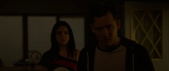Movie still from “The Strangers: Prey at Night” (2018), directed by Johannes Roberts – A man and a woman standing next to each other in the dark; Medium shot, Over the shoulder angle