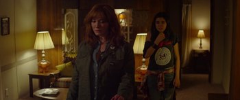 Movie still from “The Strangers: Prey at Night” (2018), directed by Johannes Roberts – Two women standing next to each other in a room; Medium shot, Over the shoulder angle