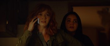 Movie still from “The Strangers: Prey at Night” (2018), directed by Johannes Roberts – Two women standing next to each other in a dark room; Close Up shot, Low angle
