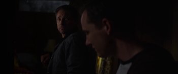 Movie still from “The Strangers: Prey at Night” (2018), directed by Johannes Roberts – Two men are looking at each other in the dark; Close Up shot, Over the shoulder angle