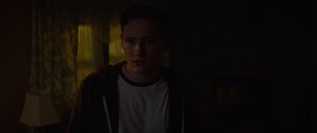 Movie still from “The Strangers: Prey at Night” (2018), directed by Johannes Roberts – A man in a white shirt and a brown jacket; Close Up shot, Over the shoulder angle