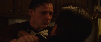 Movie still from “The Strangers: Prey at Night” (2018), directed by Johannes Roberts – A man and a woman in a dark room; Close Up shot, Over the shoulder angle