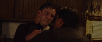 Movie still from “The Strangers: Prey at Night” (2018), directed by Johannes Roberts – Two men one of whom is touching the other's face; Close Up shot, Over the shoulder angle