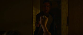 Movie still from “The Strangers: Prey at Night” (2018), directed by Johannes Roberts – A man holding a gun in front of a mirror; Close Up shot, Over the shoulder angle