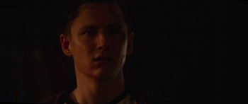 Movie still from “The Strangers: Prey at Night” (2018), directed by Johannes Roberts – A young man is looking into the distance; Close Up shot, Low angle