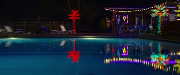 Movie still from “The Strangers: Prey at Night” (2018), directed by Johannes Roberts – Two people standing by a pool at night; Extreme Wide shot, Over the shoulder angle