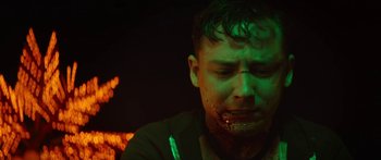 Movie still from “The Strangers: Prey at Night” (2018), directed by Johannes Roberts – A man with a knife in his mouth; Close Up shot, Low angle