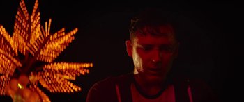 Movie still from “The Strangers: Prey at Night” (2018), directed by Johannes Roberts – A man in a red shirt is in the dark; Close Up shot, Low angle